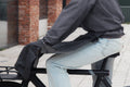Cyclist wearing the Manta waterproof leg cover over jeans, side view